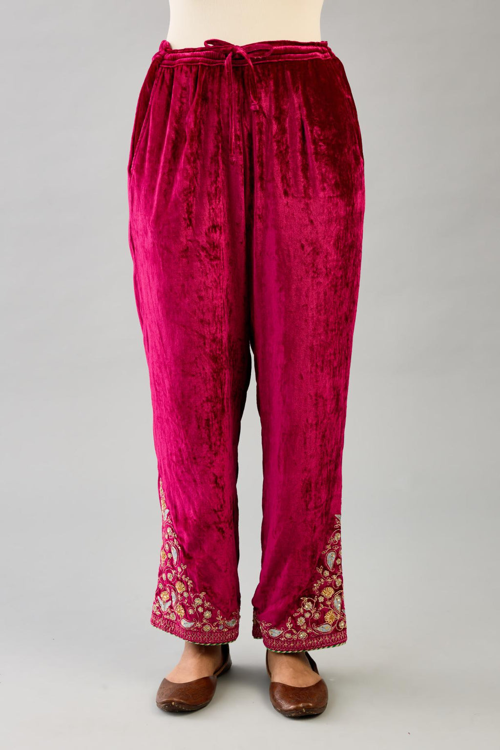Fuchsia silk velvet straight pants with dori and contrast silk thread embroidery, detailed with gold sequins work.