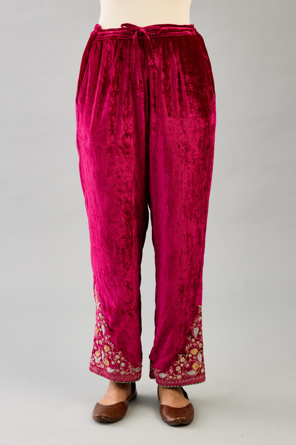 Fuchsia silk velvet straight pants with dori and contrast silk thread embroidery, detailed with gold sequins work.