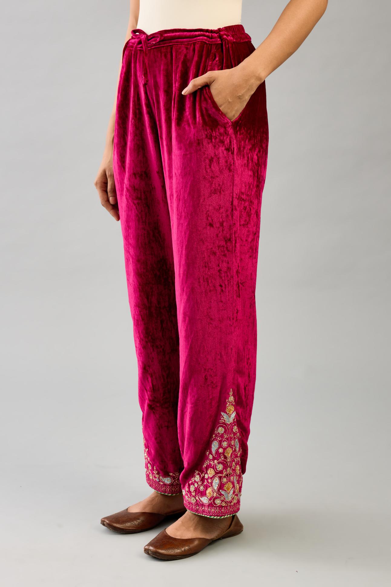 Fuchsia silk velvet straight pants with dori and contrast silk thread embroidery, detailed with gold sequins work.