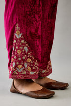 Fuchsia silk velvet straight pants with dori and contrast silk thread embroidery, detailed with gold sequins work.