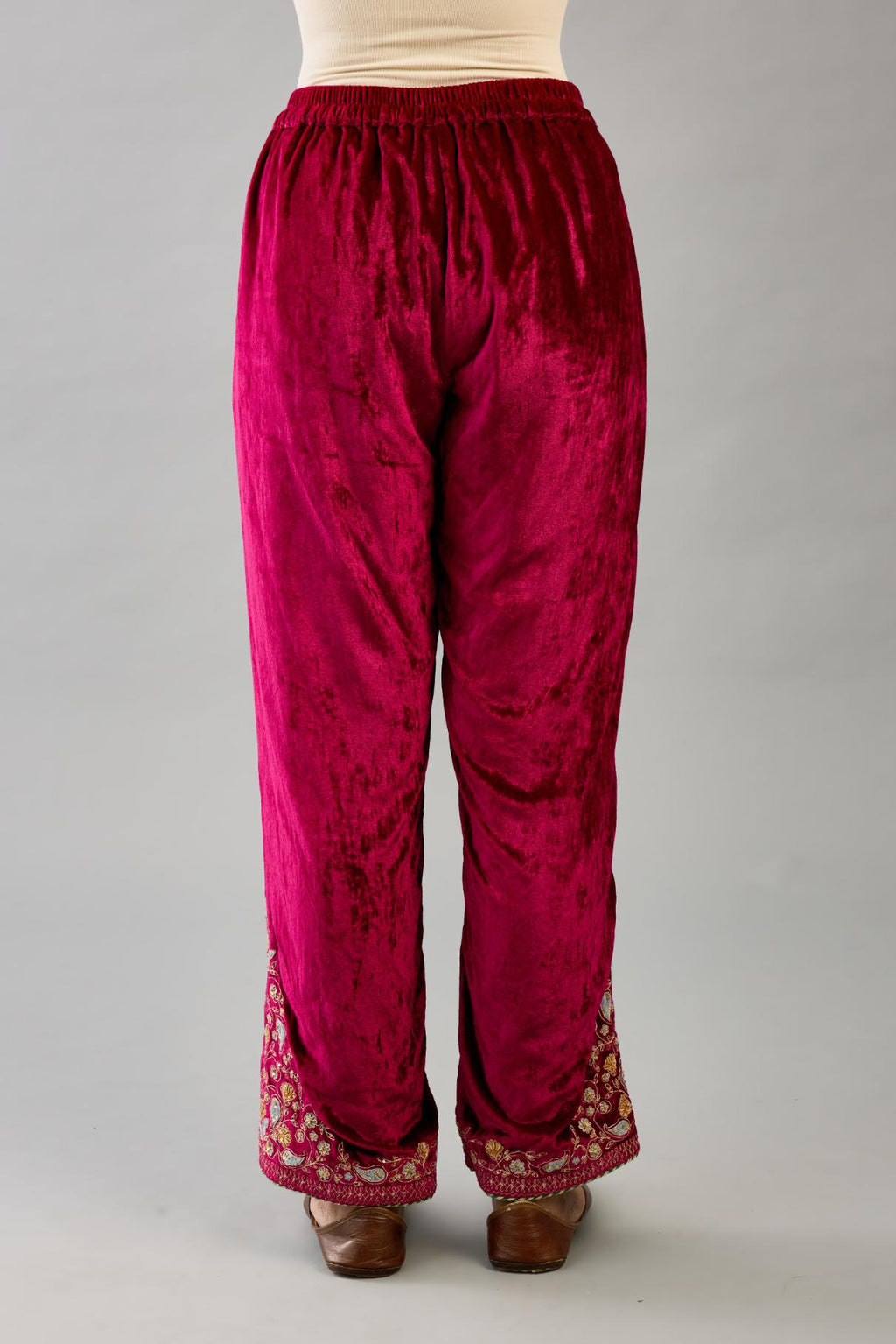 Fuchsia silk velvet straight pants with dori and contrast silk thread embroidery, detailed with gold sequins work.