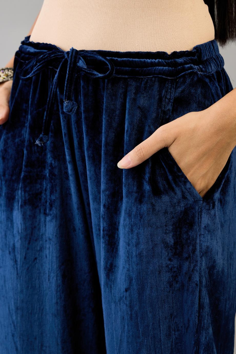 Blue silk velvet straight pants with dori and contrast silk thread embroidery, detailed with gold sequins work.