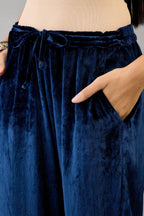 Blue silk velvet straight pants with dori and contrast silk thread embroidery, detailed with gold sequins work.