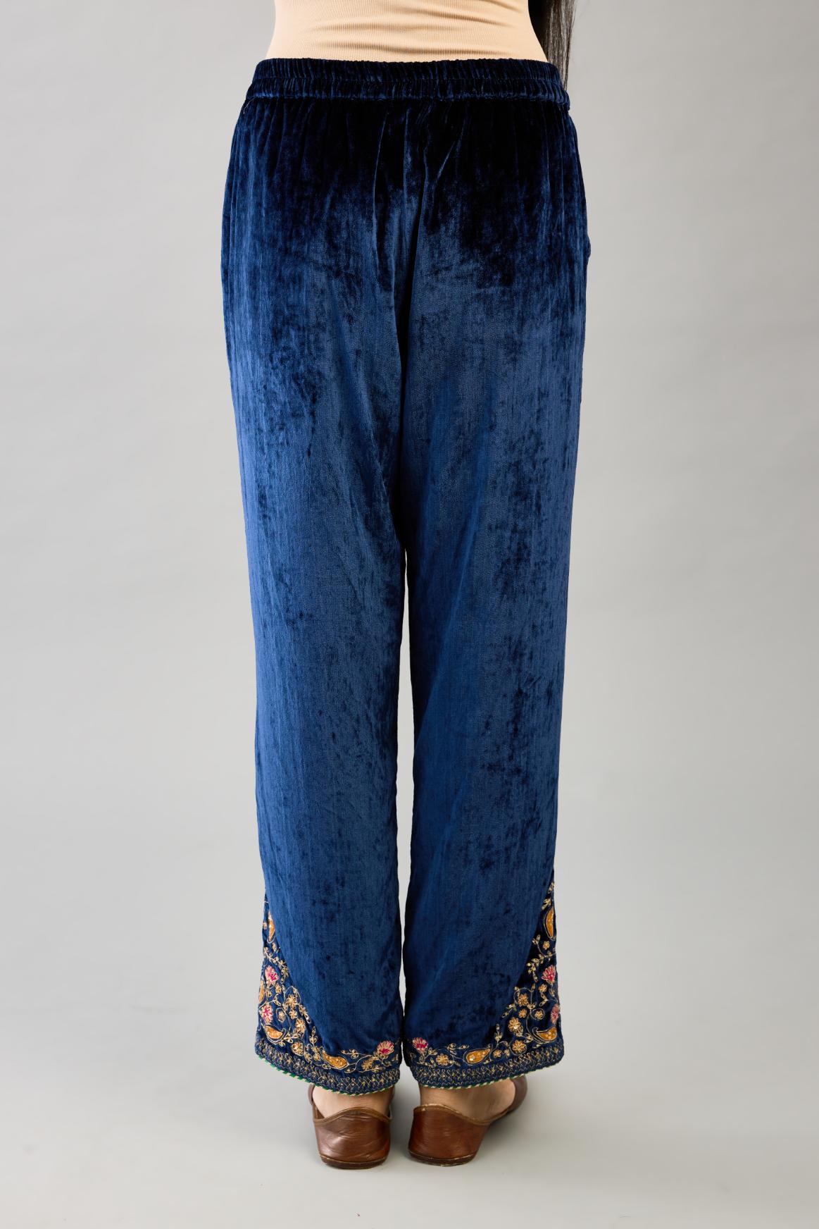 Blue silk velvet straight pants with dori and contrast silk thread embroidery, detailed with gold sequins work.