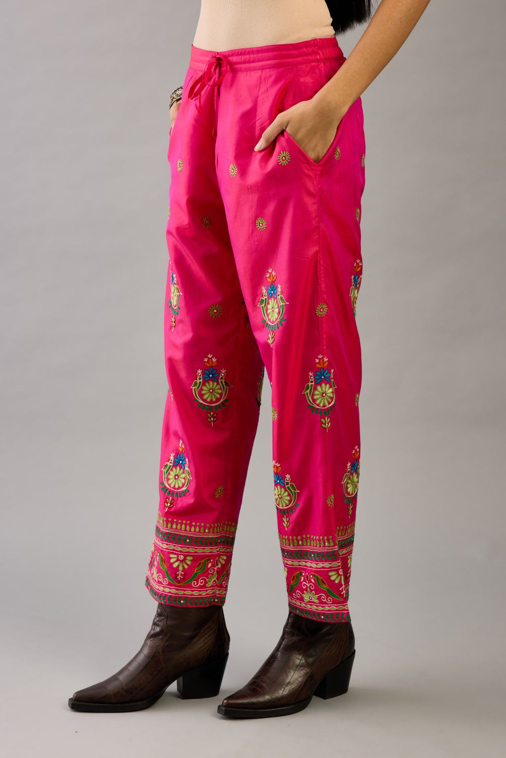 Fuchsia silk straight pants with all over multi color embroidery detailed with sequins.