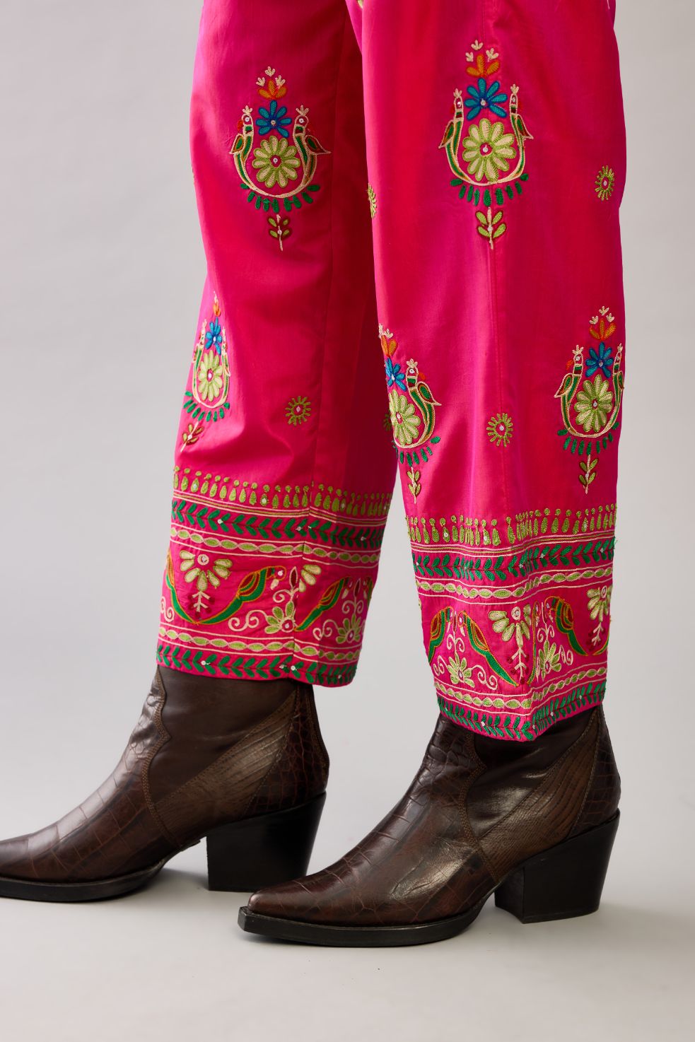Fuchsia silk straight pants with all over multi color embroidery detailed with sequins.