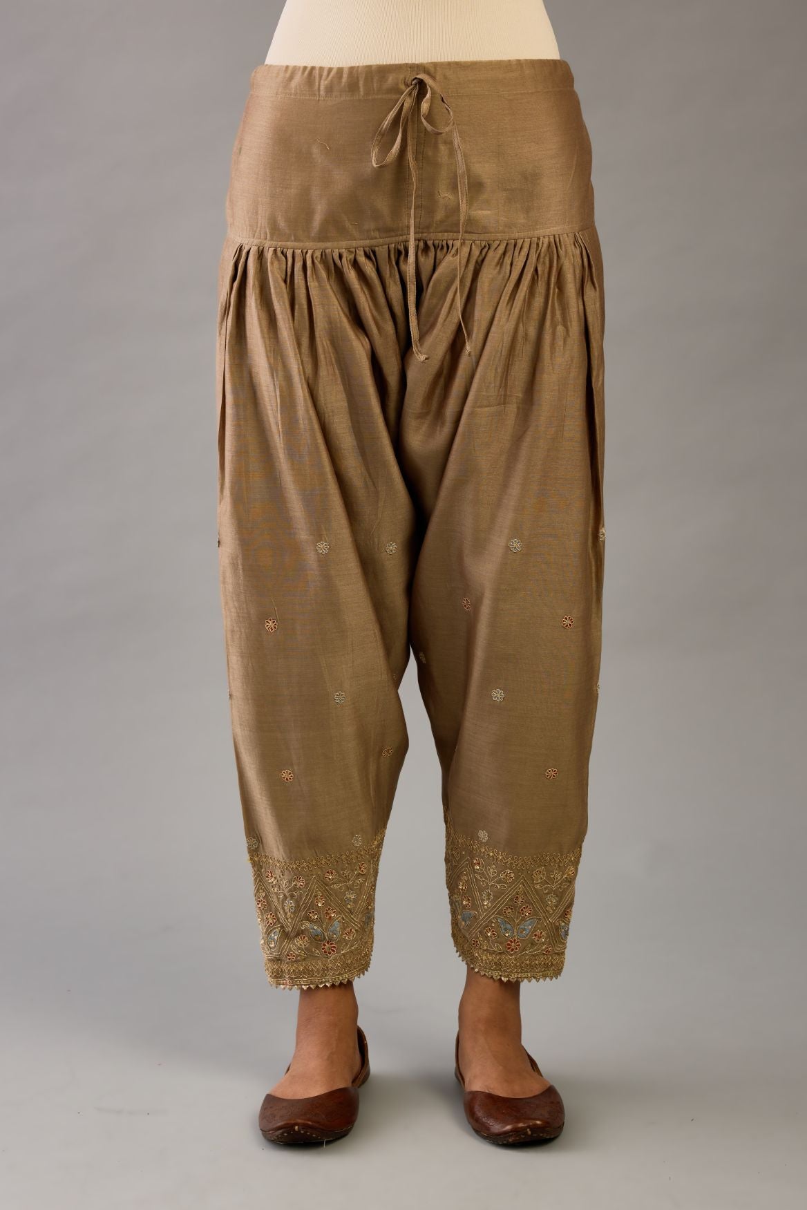 Taupe silk chanderi narrow salwar with dori and contrast silk thread embroidery,  detailed with gold sequins work.
