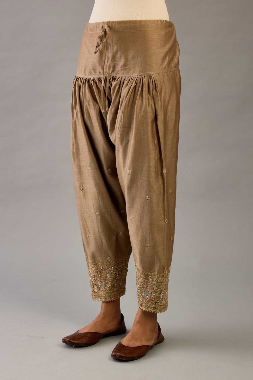Taupe silk chanderi narrow salwar with dori and contrast silk thread embroidery,  detailed with gold sequins work.
