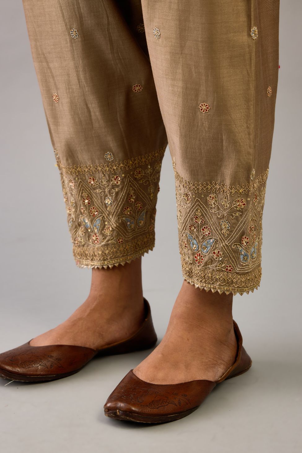 Taupe silk chanderi narrow salwar with dori and contrast silk thread embroidery,  detailed with gold sequins work.