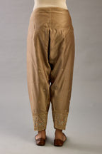 Taupe silk chanderi narrow salwar with dori and contrast silk thread embroidery,  detailed with gold sequins work.