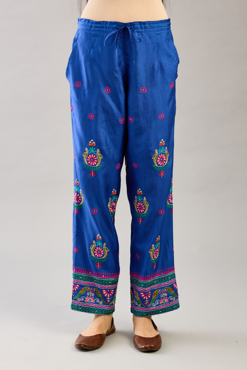 Blue silk straight pants with all over multi color embroidery detailed with sequins.