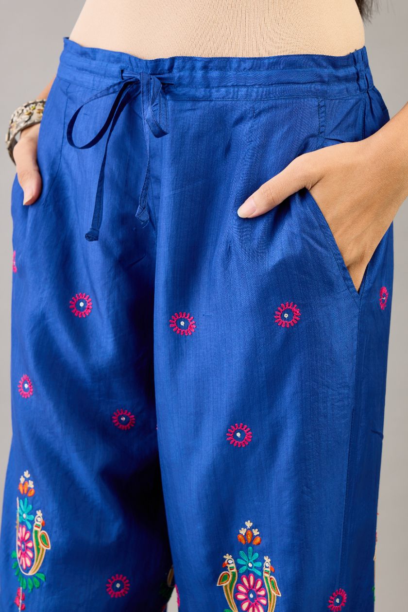 Blue silk straight pants with all over multi color embroidery detailed with sequins.