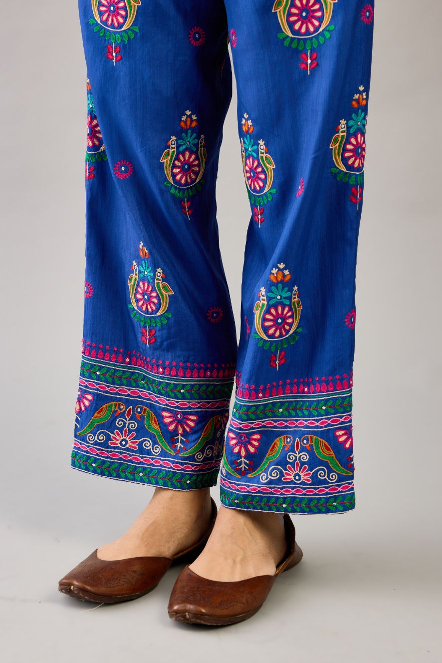 Blue silk straight pants with all over multi color embroidery detailed with sequins.