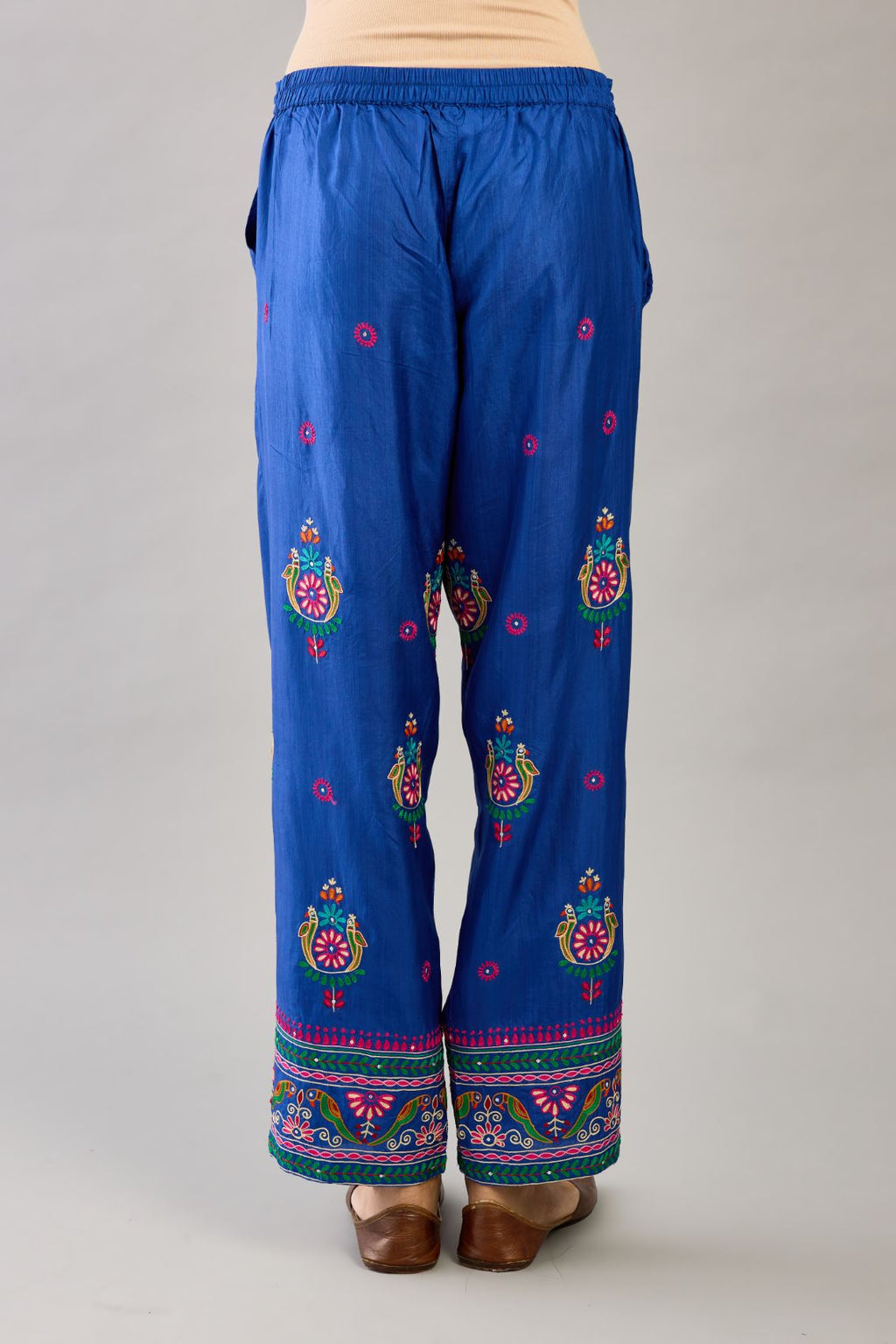 Blue silk straight pants with all over multi color embroidery detailed with sequins.