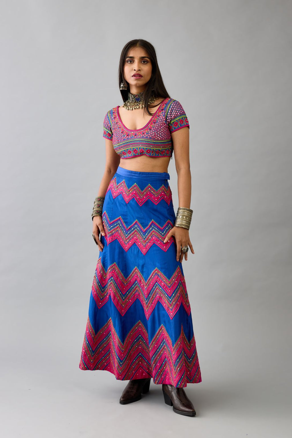 Blue silk embroidered choli set with deep round neck and princess seams.