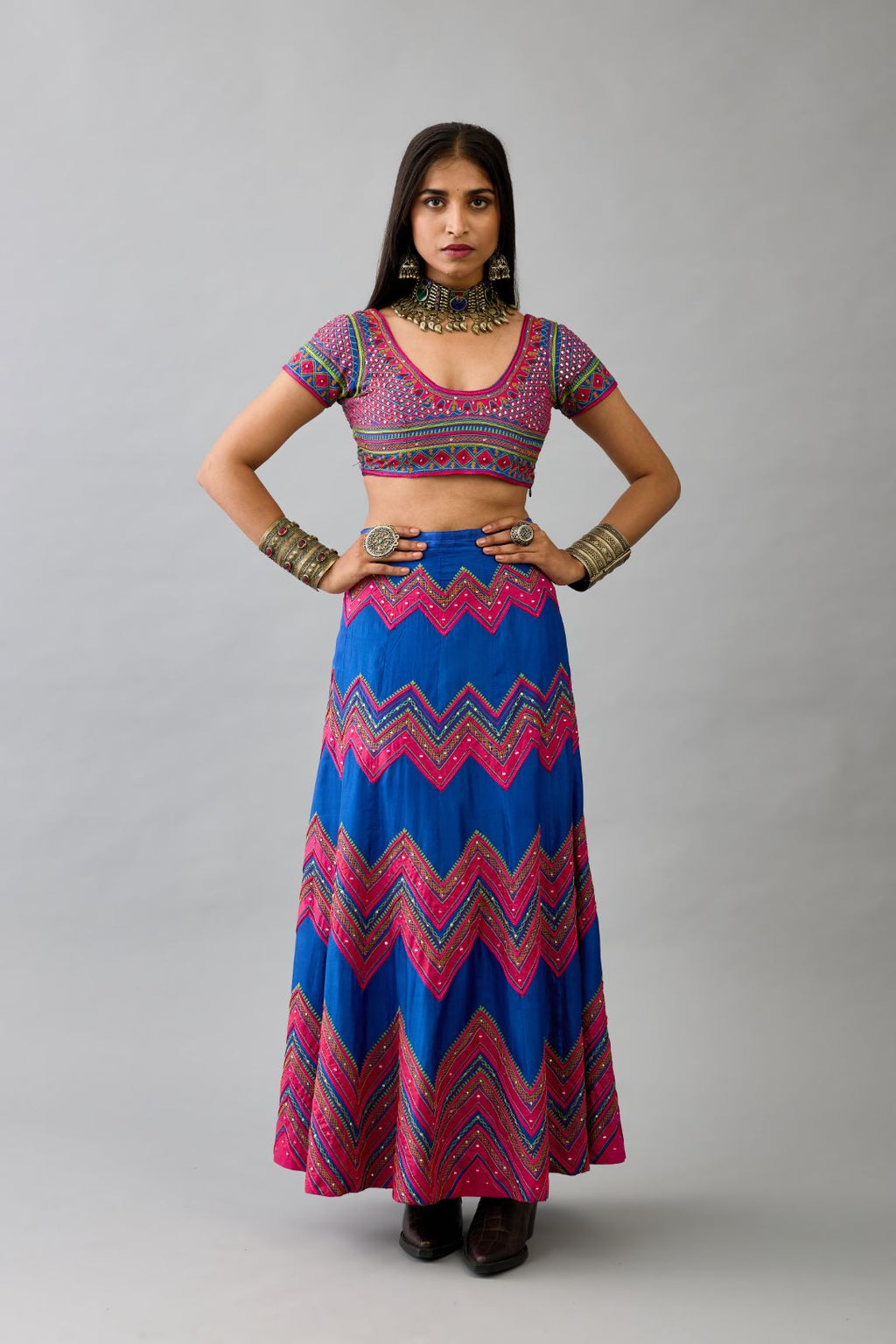 Blue silk embroidered choli set with deep round neck and princess seams.