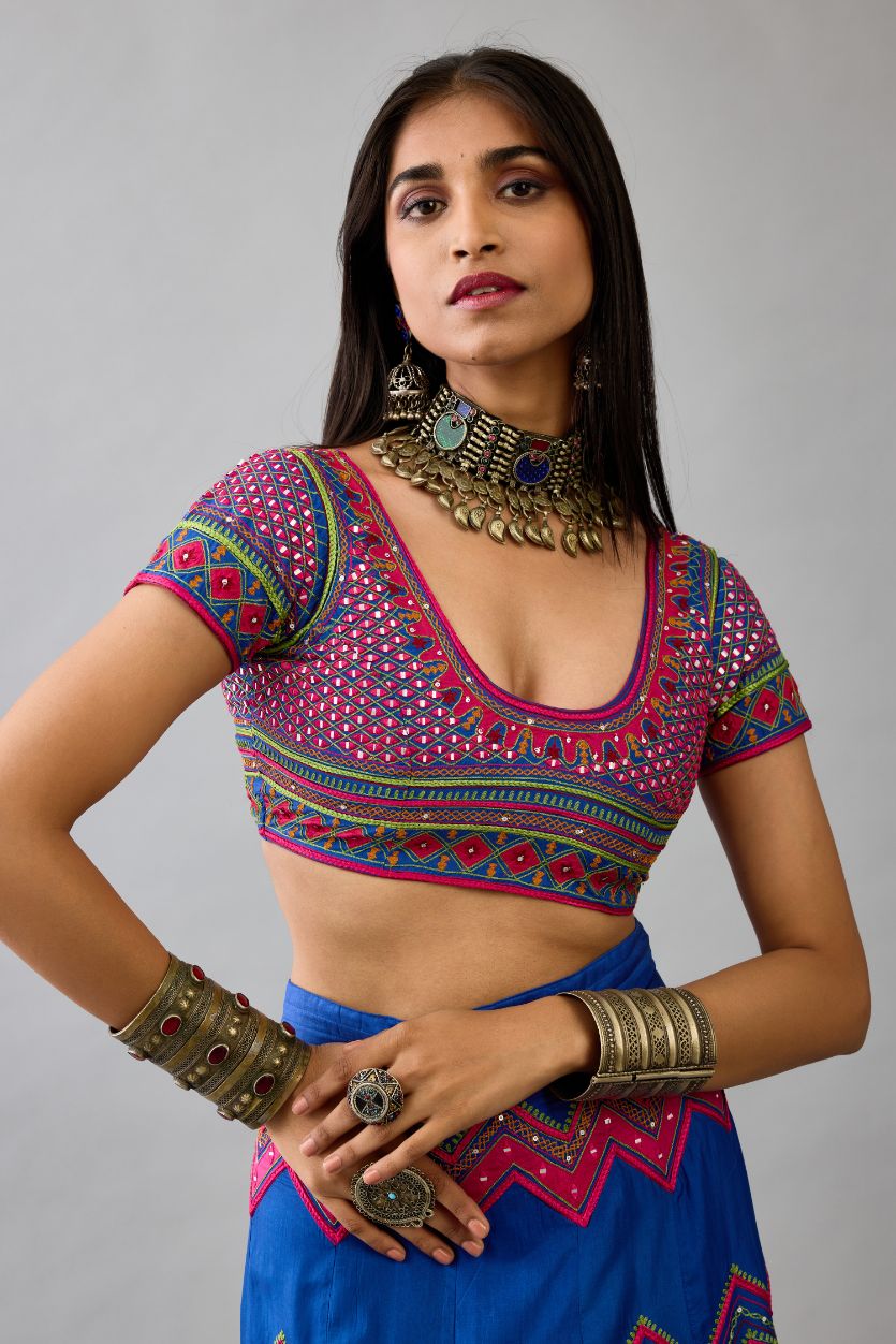 Blue silk embroidered choli set with deep round neck and princess seams.