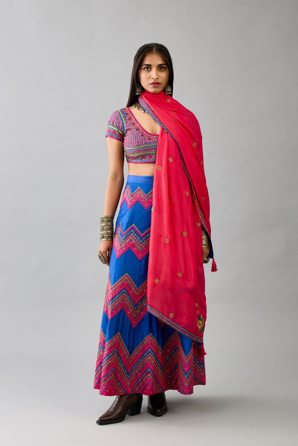 Blue silk embroidered choli set with deep round neck and princess seams.