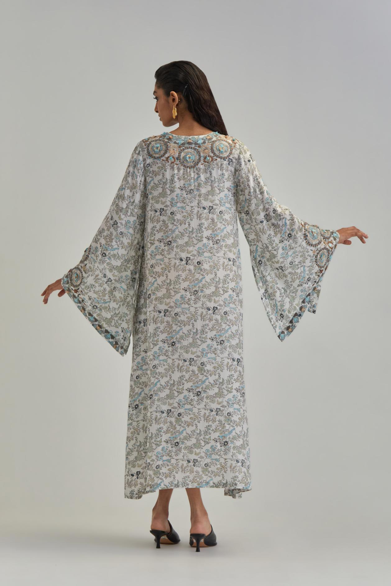 Off White long A-line kaftan with all-over earthy coloured hand block print and appliqué flowers, thread work and silk tassels.