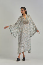 Off White long A-line kaftan with all-over earthy coloured hand block print and appliqué flowers, thread work and silk tassels.