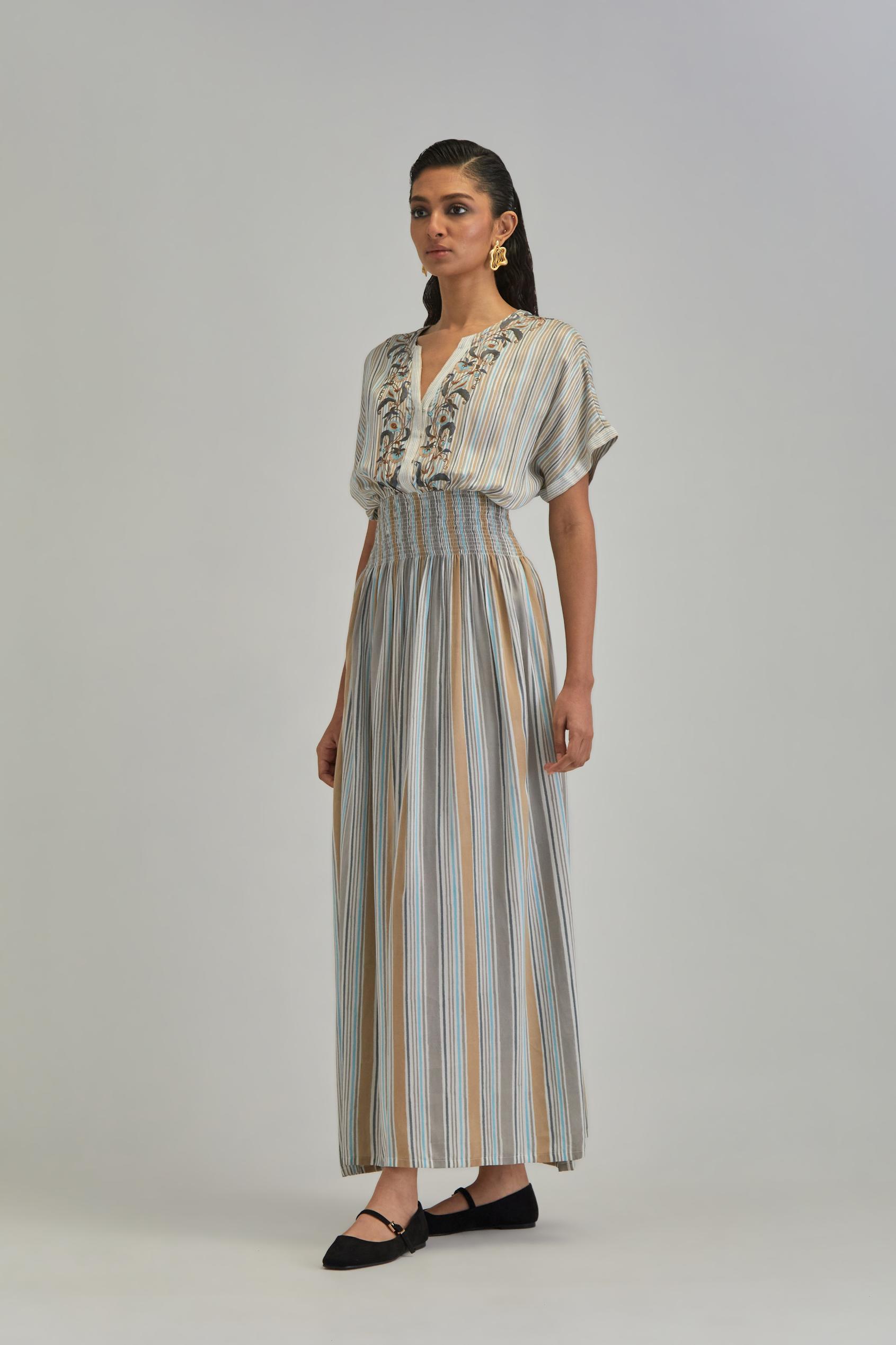 Off White long dress with all-over earthy coloured stripe hand block print and Aari thread work at neck.