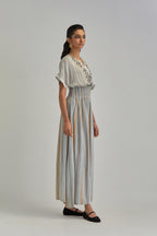 Off White long dress with all-over earthy coloured stripe hand block print and Aari thread work at neck.