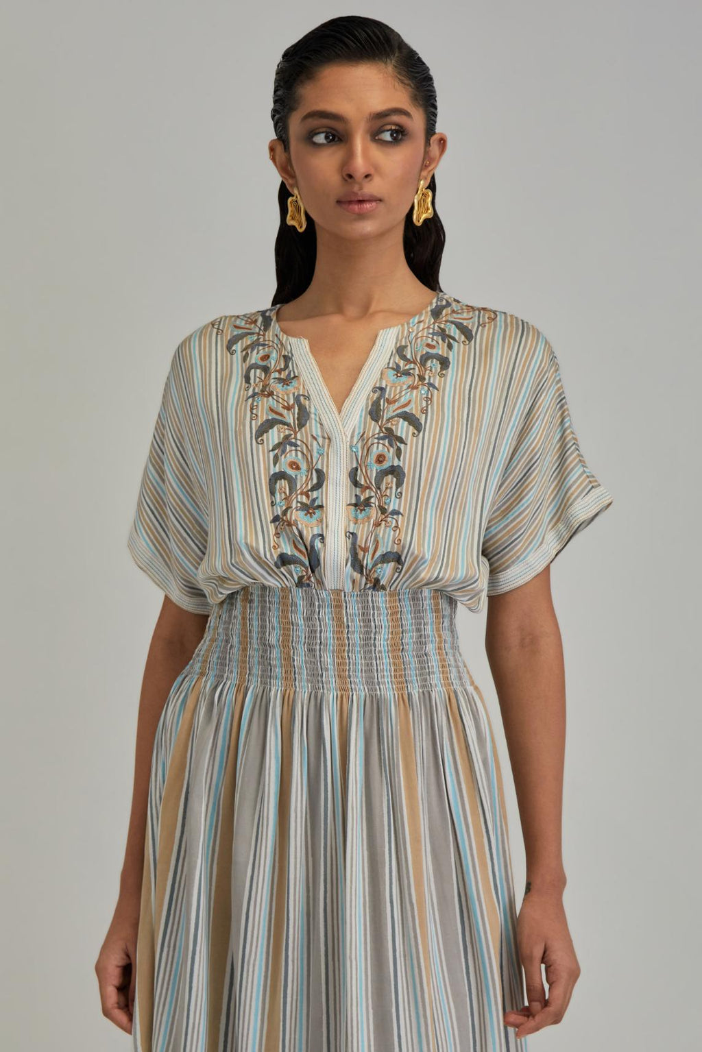 Off White long dress with all-over earthy coloured stripe hand block print and Aari thread work at neck.