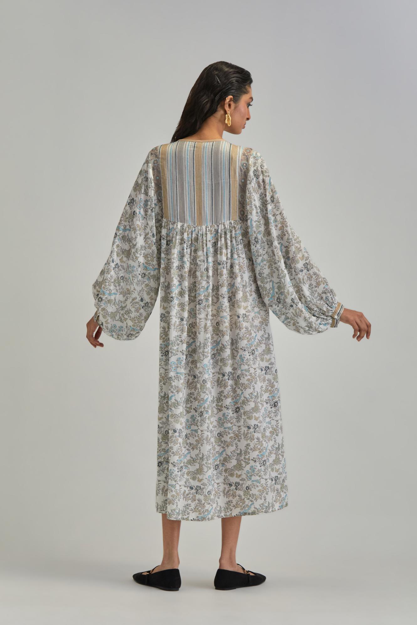 Off White dress with all-over earthy coloured hand block print and Aari thread work yoke.