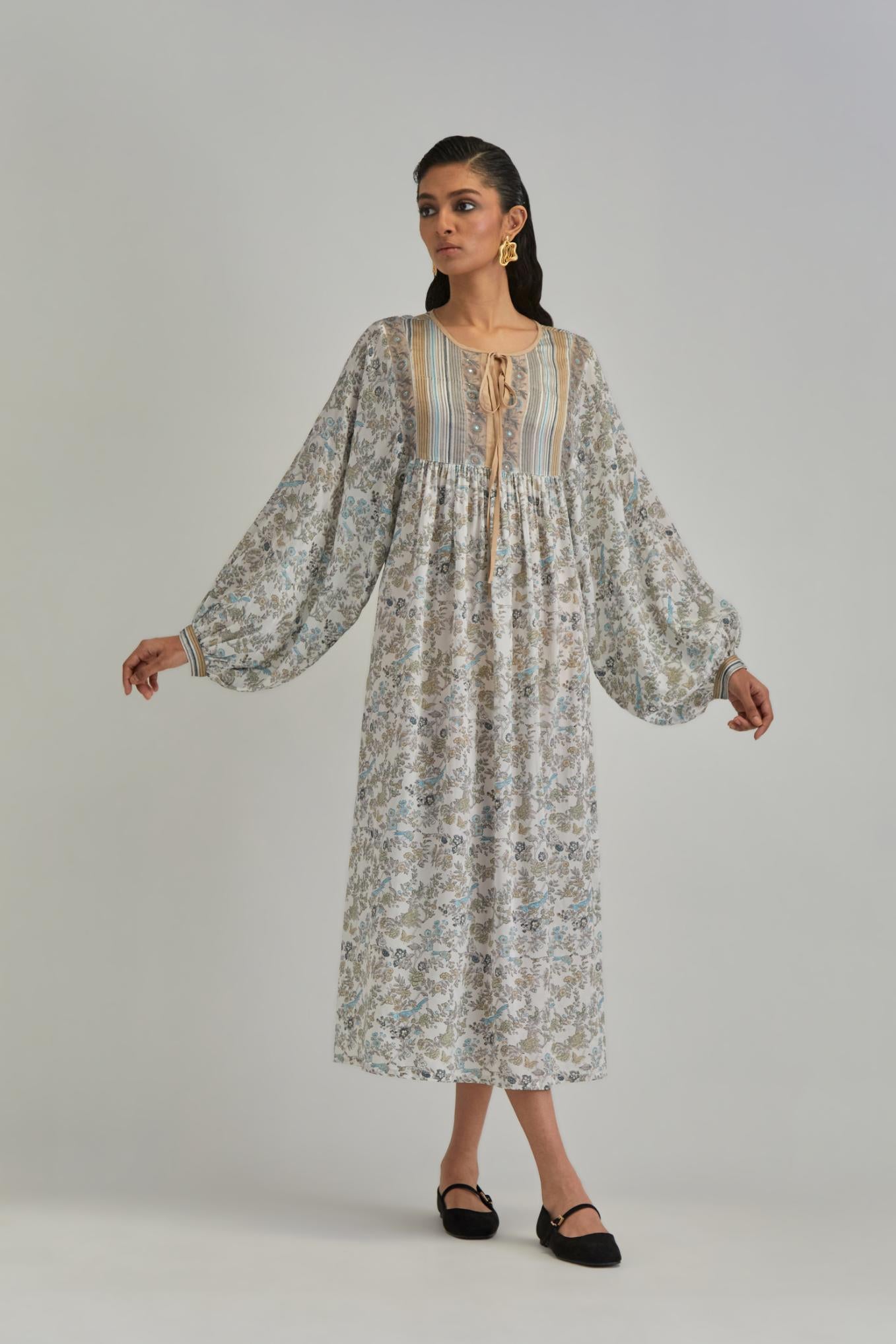 Off White dress with all-over earthy coloured hand block print and Aari thread work yoke.