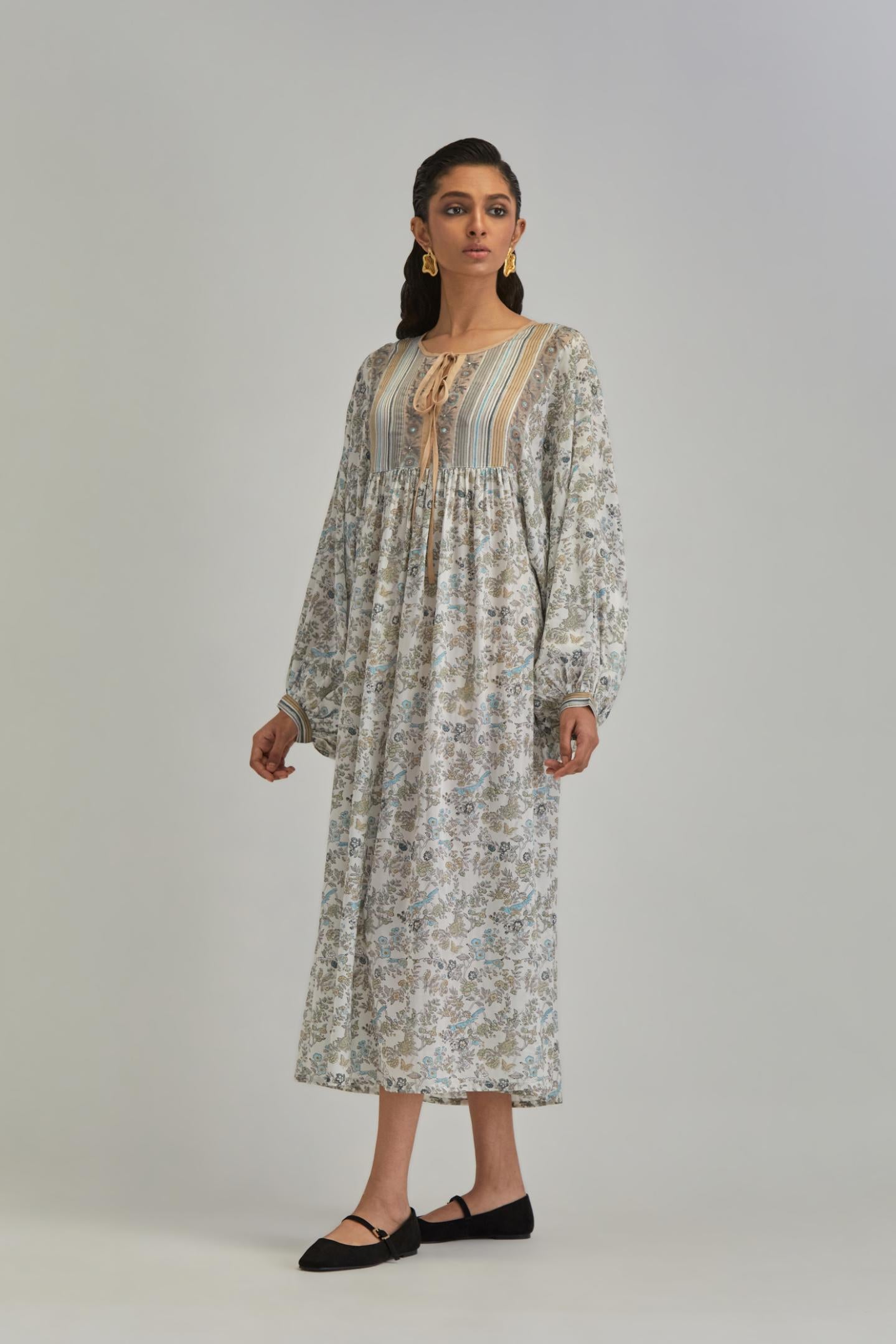 Off White dress with all-over earthy coloured hand block print and Aari thread work yoke.