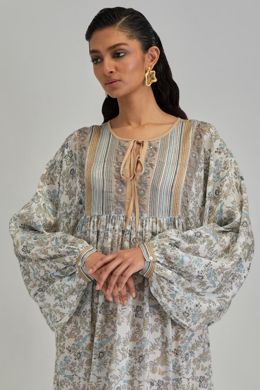 Off White dress with all-over earthy coloured hand block print and Aari thread work yoke.
