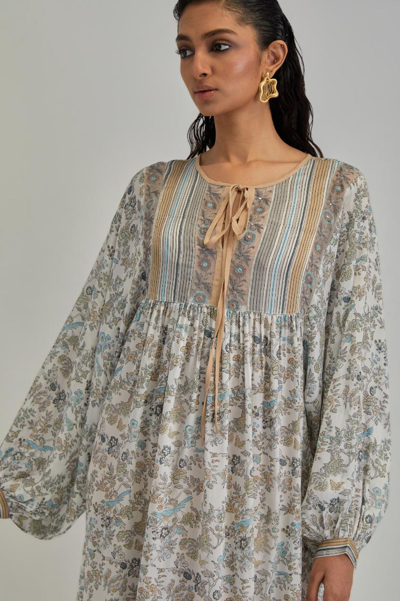 Off White dress with all-over earthy coloured hand block print and Aari thread work yoke.