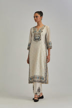 Off White slim fit straight kurta set, decorated with bold appliqué borders all along the side seam, hem and sleeve cuffs.
