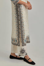 Off White slim fit straight kurta set, decorated with bold appliqué borders all along the side seam, hem and sleeve cuffs.