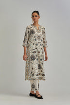 Off White straight kurta set, fully embroidered with bold appliqué flowers, earthy-coloured Aari thread work and silk tassels.