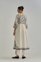 Off White silk Chanderi kurta-dress set with a wavy high-waist and fine gathers. The yoke is fully embroidered with earthy coloured circular appliqué and Aari thread work.
