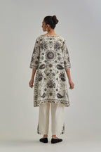 Off White short A-line silk Chanderi kurta set, fully embroidered with earthy coloured appliqué with Aari thread work and silk tassels.