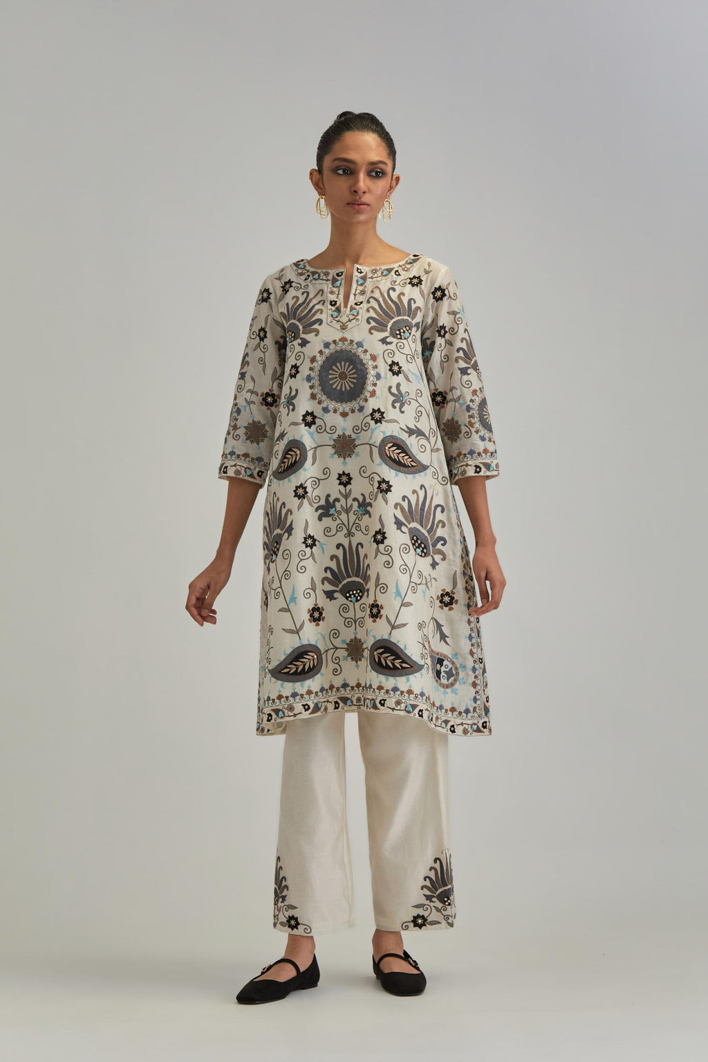 Off White short A-line silk Chanderi kurta set, fully embroidered with earthy coloured appliqué with Aari thread work and silk tassels.