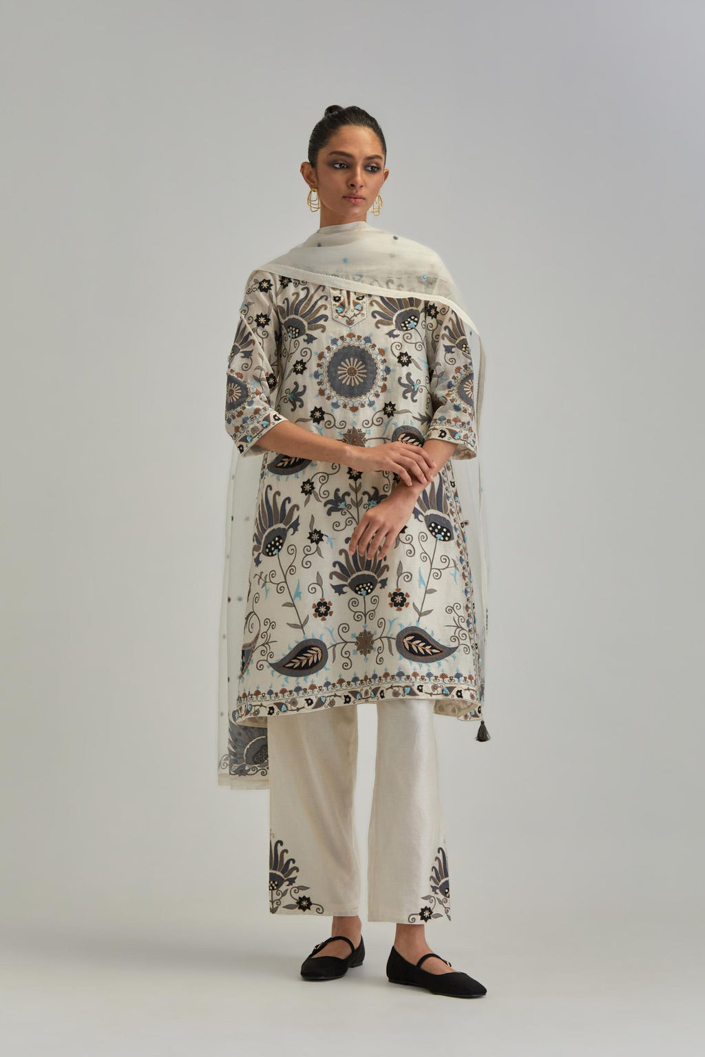 Off White short A-line silk Chanderi kurta set, fully embroidered with earthy coloured appliqué with Aari thread work and silk tassels.