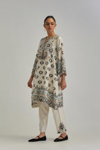 Off White silk Chanderi straight hem mid-length abha style kurta set with bold appliqué embroidery along with earthy-coloured Aari thread work and tassels.