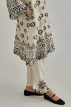Off White silk Chanderi straight hem mid-length abha style kurta set with bold appliqué embroidery along with earthy-coloured Aari thread work and tassels.