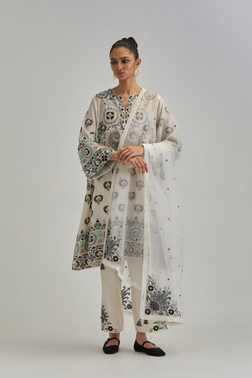 Off White silk Chanderi straight hem mid-length abha style kurta set with bold appliqué embroidery along with earthy-coloured Aari thread work and tassels.