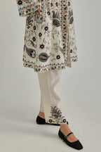 Off White short front open A-line jacket, fully embroidered with bold appliqué flowers, earthy-coloured Aari thread work and silk tassels, paired with Off white silk Chanderi straight pants with earthy coloured appliqué at hem.