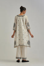 Off White silk Chanderi short V-neck kurta set, with straight hem and side pockets, decorated with fine appliqué and Aari thread embroidery.