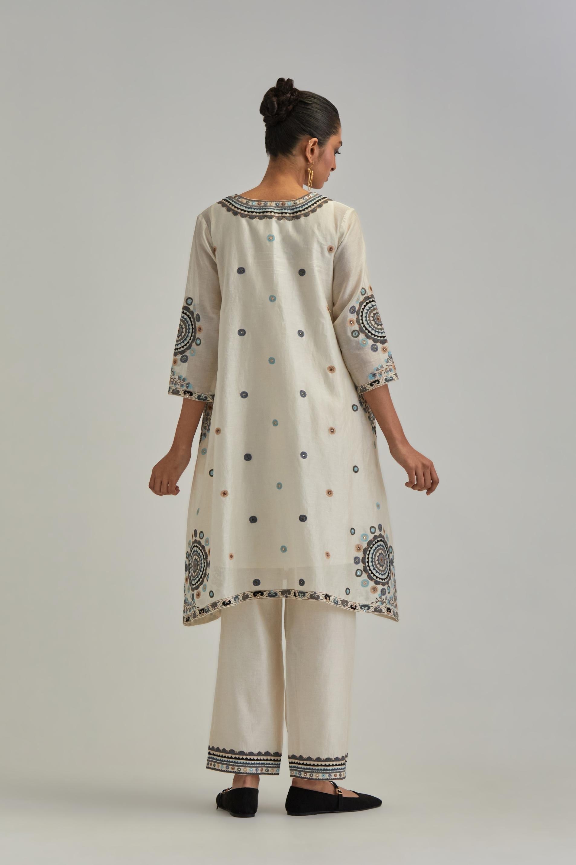 Off White silk Chanderi short V-neck kurta set, with straight hem and side pockets, decorated with fine appliqué and Aari thread embroidery.