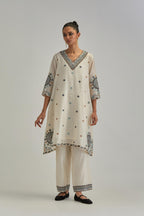 Off White silk Chanderi short V-neck kurta set, with straight hem and side pockets, decorated with fine appliqué and Aari thread embroidery.