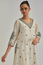 Off White silk Chanderi short V-neck kurta set, with straight hem and side pockets, decorated with fine appliqué and Aari thread embroidery.