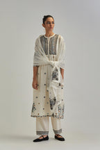 Off White silk Chanderi gathered kurta-dress set with appliqué stripes along with Aari thread work flowers and floral trellises along with a circular appliqued motif.