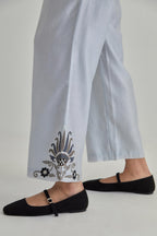 Blue silk Chanderi straight pants with earthy coloured appliqué at hem.