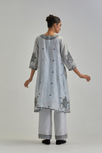 Blue silk Chanderi short V-neck kurta set, with straight hem and side pockets, decorated with fine appliqué and Aari thread embroidery.